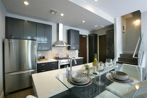 a kitchen with stainless steel appliances and a table