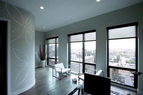 a living room with a view of the city from the window