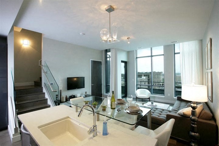 a living room with a sink and a couch and a television