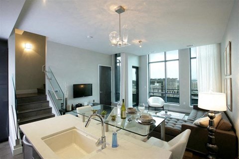 a living room with a sink and a couch and a television