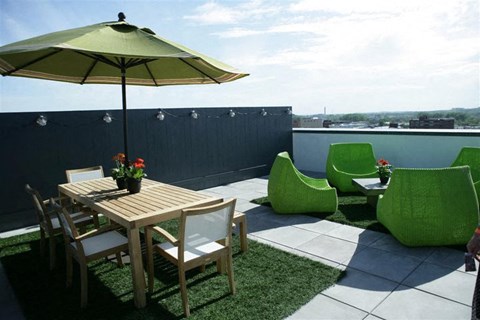 a patio with a table and chairs and an umbrella
