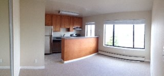 an empty kitchen with a large window
