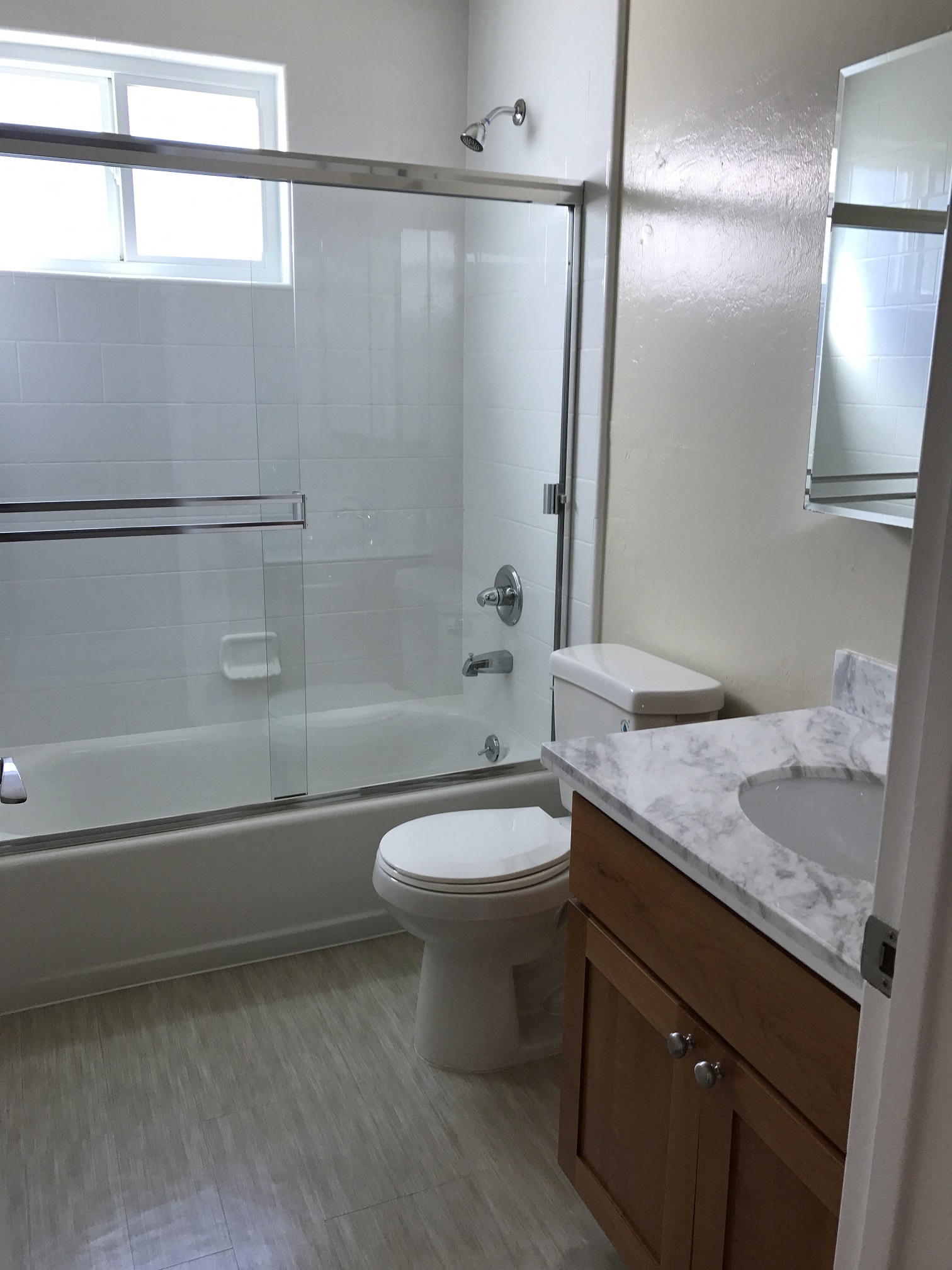 an empty bathroom with a shower toilet and sink