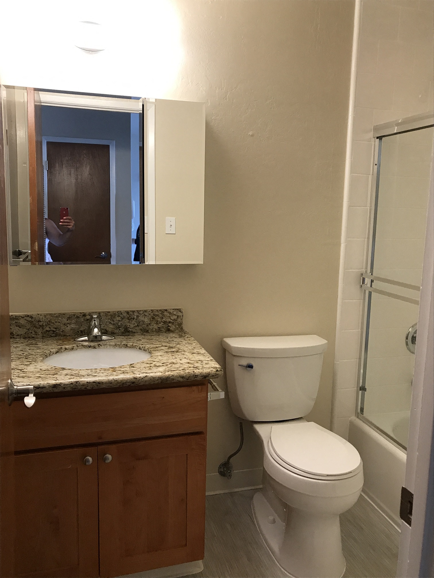 a bathroom with a toilet and a sink and a shower