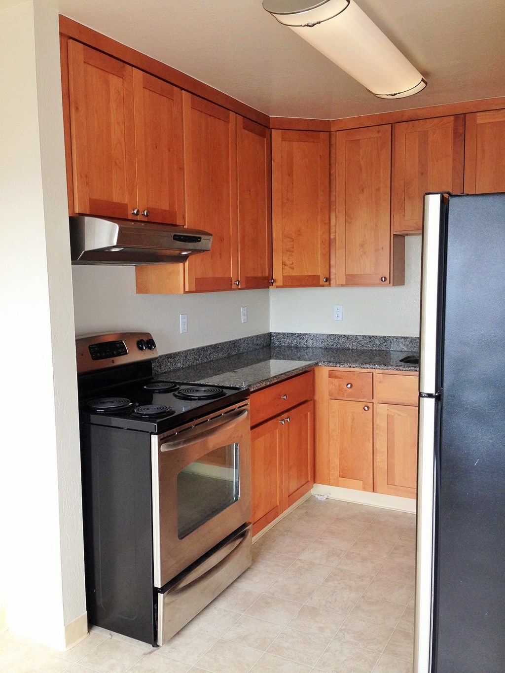 a kitchen with stainless steel appliances and wooden cabinets