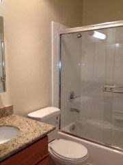 a bathroom with a toilet and a sink and a shower