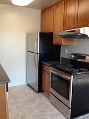 a kitchen with a stove and a refrigerator