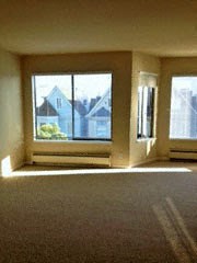 an empty living room with a large window