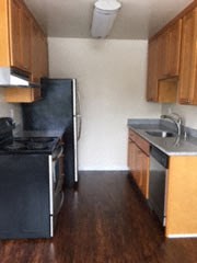 a kitchen with a stove and a sink and a refrigerator