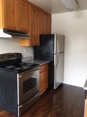 a kitchen with a stove and a refrigerator