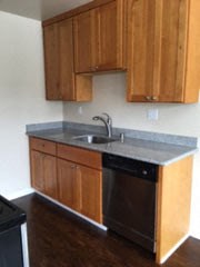 a kitchen with a sink and wooden cabinets