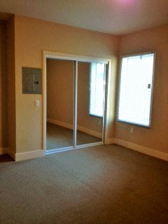 an empty living room with sliding glass doors