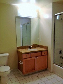 a bathroom with a sink and a shower and a toilet