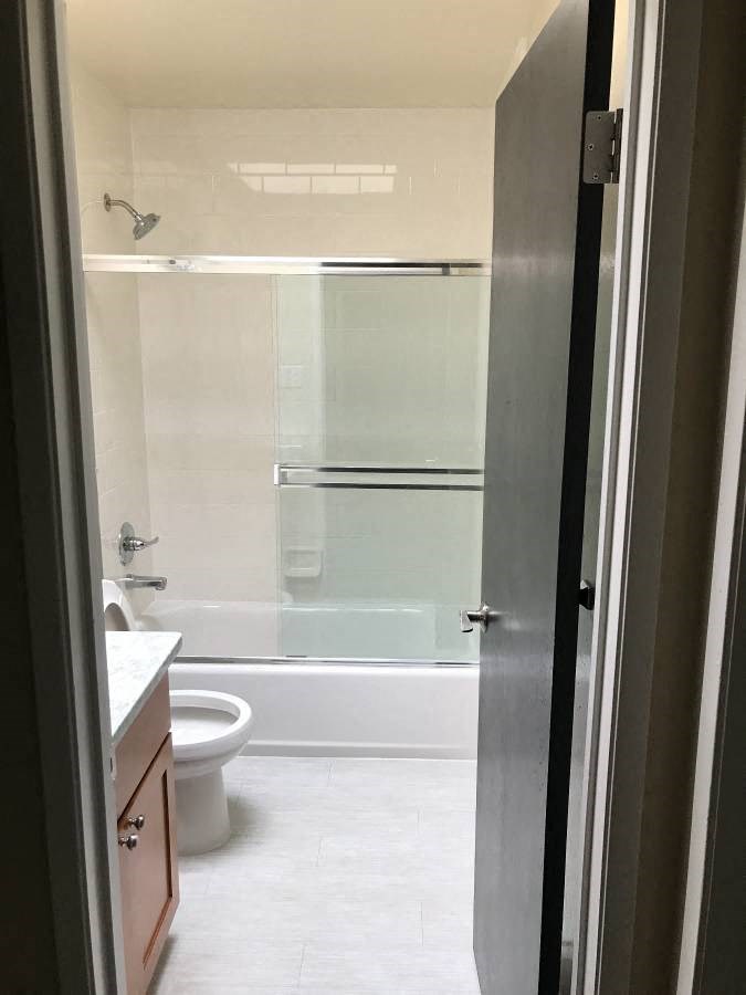 a bathroom with a toilet and a shower