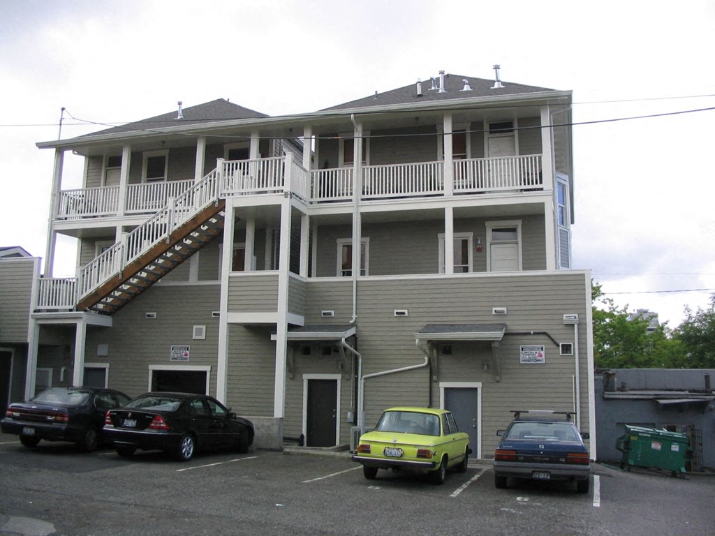 an apartment building with cars parked in front of it