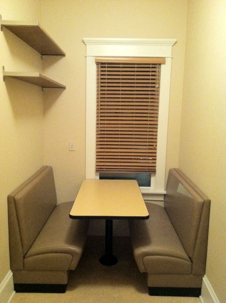 a small room with two chairs and a table