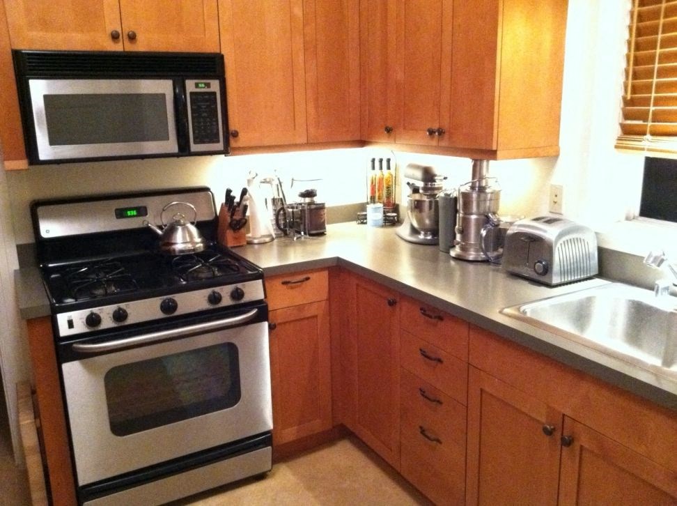 a kitchen with a stove microwave and sink