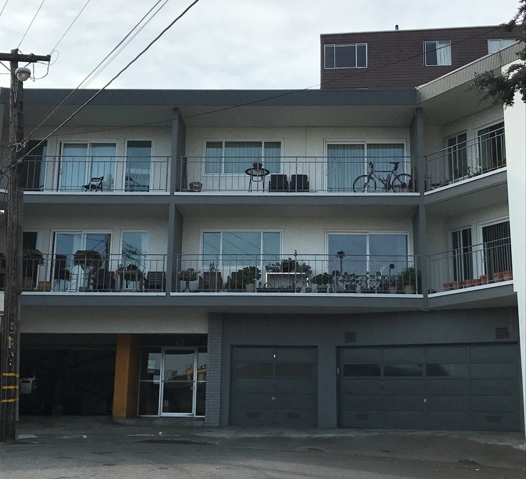 an apartment building with balconies and bikes on the balcony