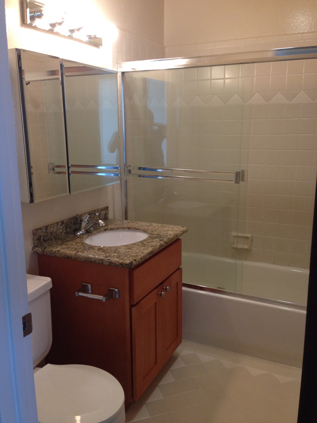 a small bathroom with a sink toilet and shower