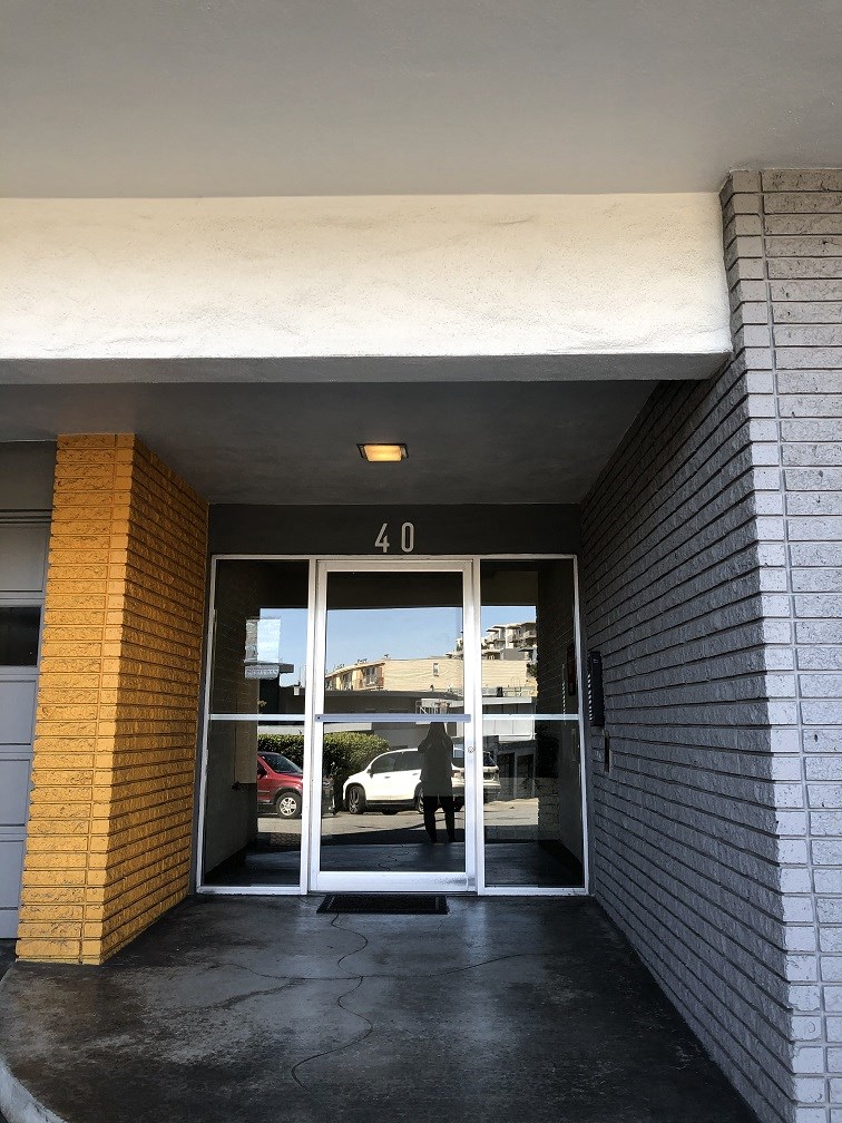 a door to a parking garage with a person walking through it