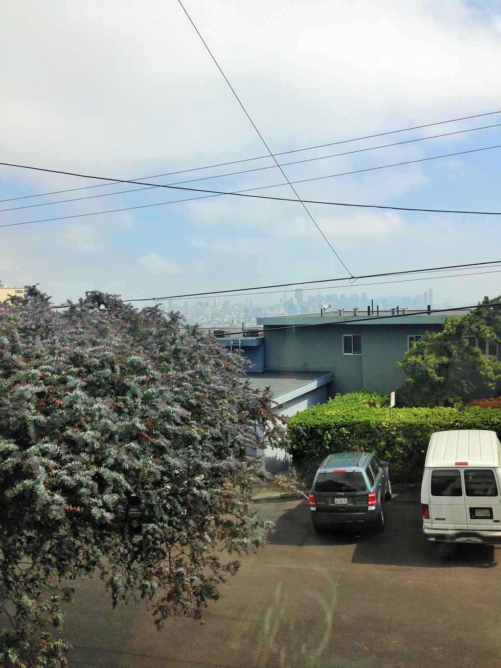 a view of a parking lot with cars and a building