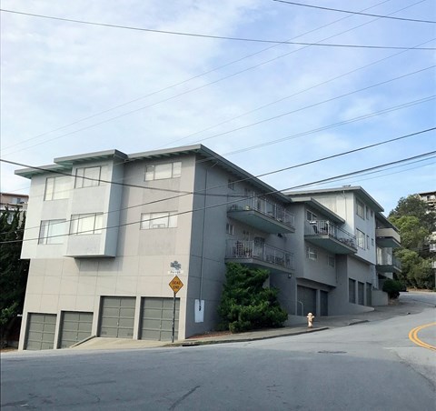 an apartment building on the corner of a street