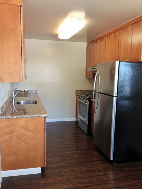 a kitchen with stainless steel appliances and wooden cabinets