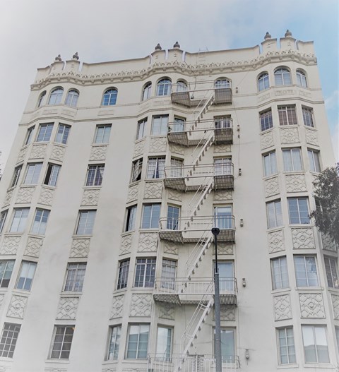 a large white building with stairs on the side of it