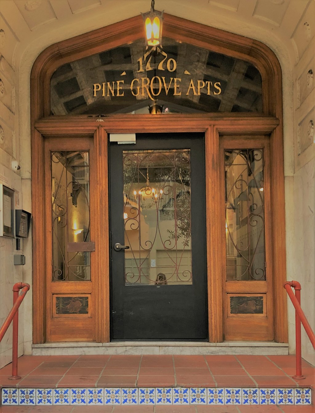 the front door of the pine grove apts building