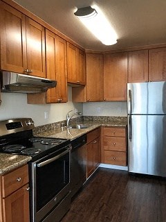 a kitchen with stainless steel appliances and wooden cabinets