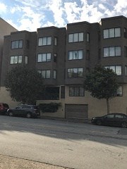 a large building with cars parked in front of it