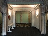 a large room with a rug and a table in it