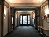 the lobby of a building with a large hallway and doors