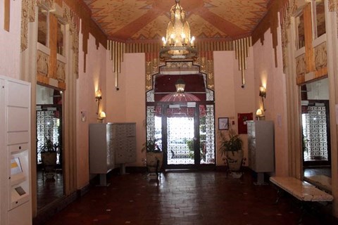 a large room with a chandelier and a door
