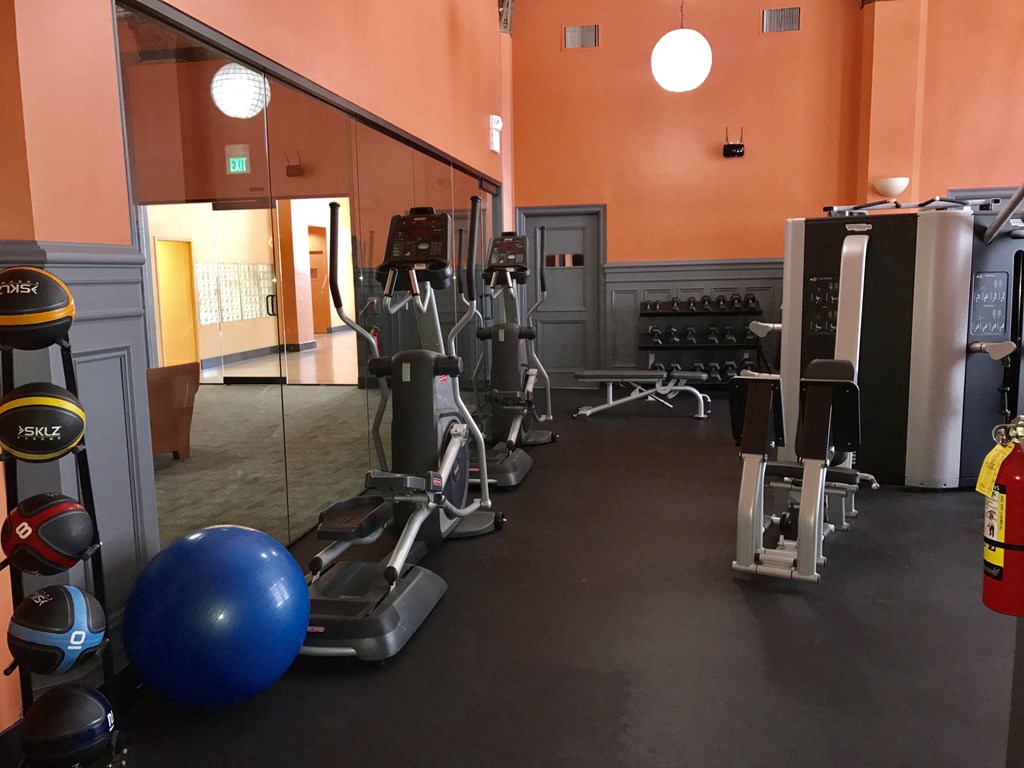 a gym with a bunch of exercise equipment in it