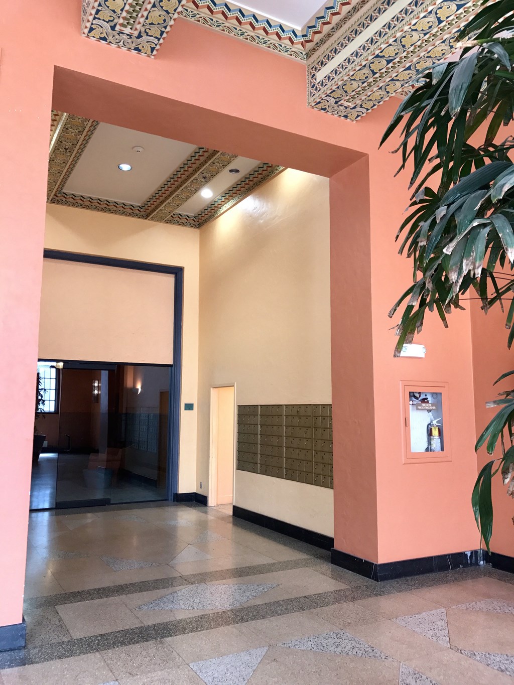 a view of the lobby of a building with a plant