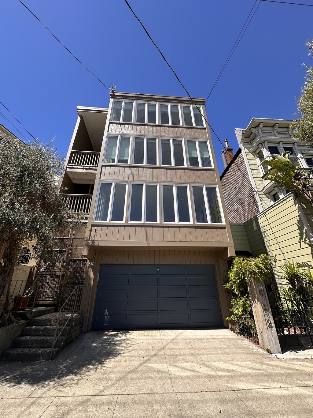 A tall building with a garage door in front.
