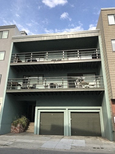 a building with two balconies and two doors