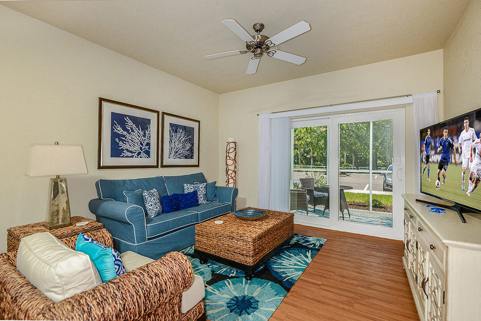 a living room with a blue couch and a tv