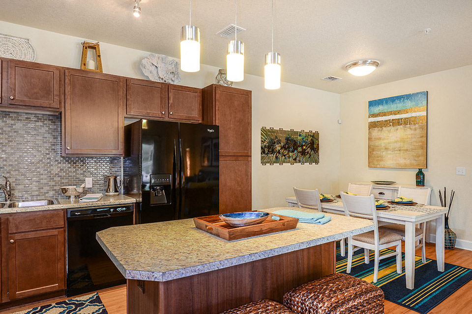 a kitchen and dining room with a table and chairs