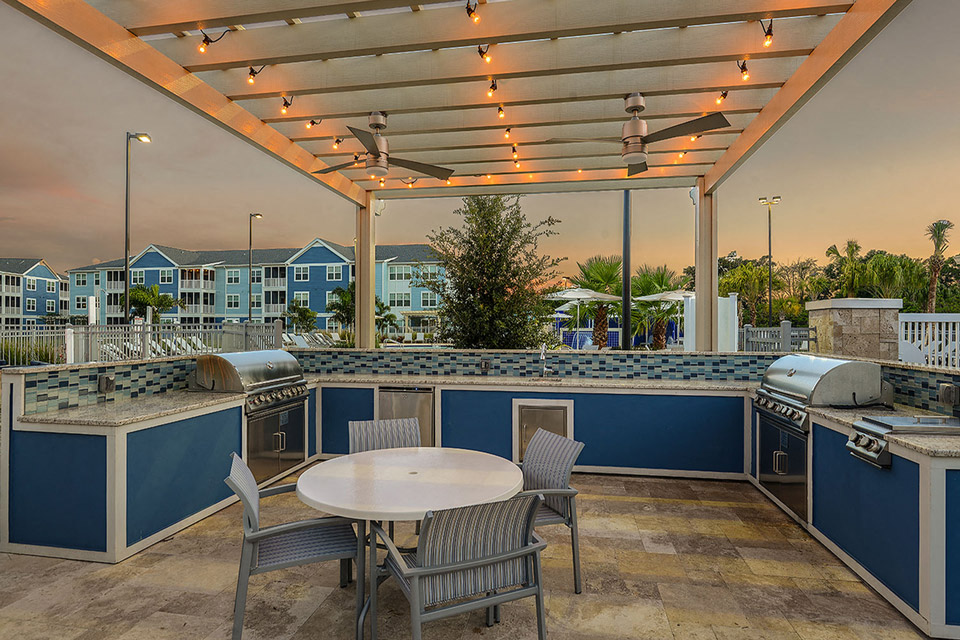 a patio with a table and chairs under a roof