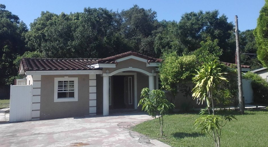 a small house with a palm tree in front of it