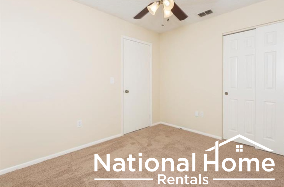 a bedroom with a ceiling fan and a closet