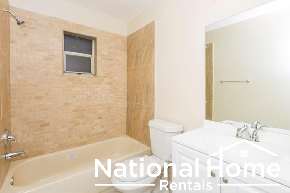 a bathroom with a tub and a toilet and a sink