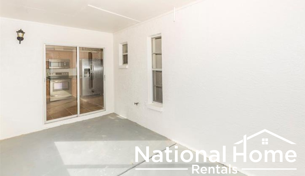 a white room with a door to a refrigerator in it