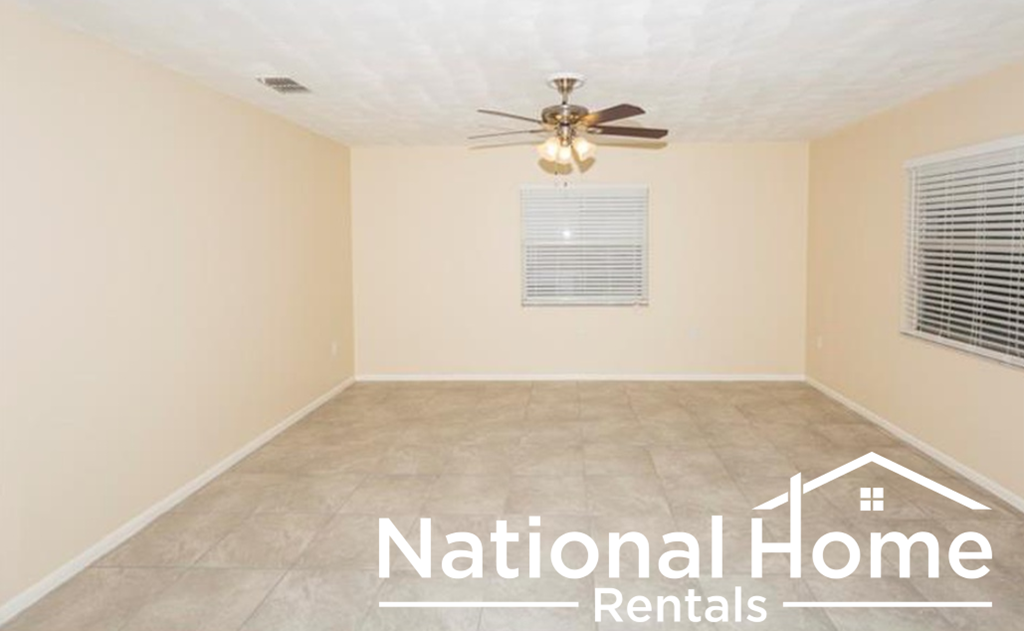 a room with a ceiling fan and a tile floor
