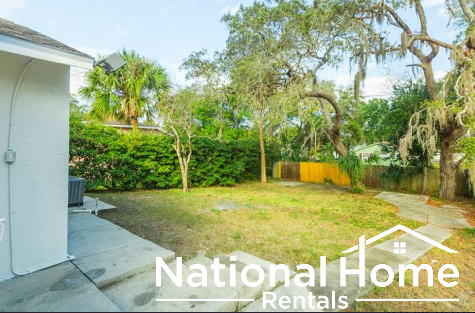 a backyard with a yard and a house