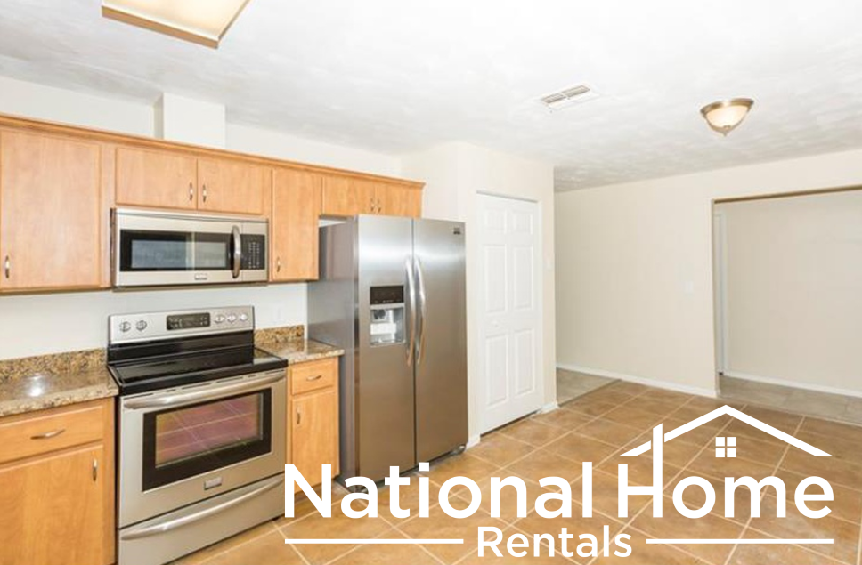 a kitchen with wooden cabinets and stainless steel appliances