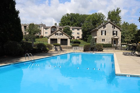 a large swimming pool with houses in the background