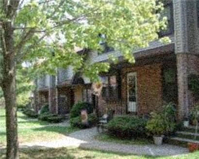 a brick house with a tree in front of it